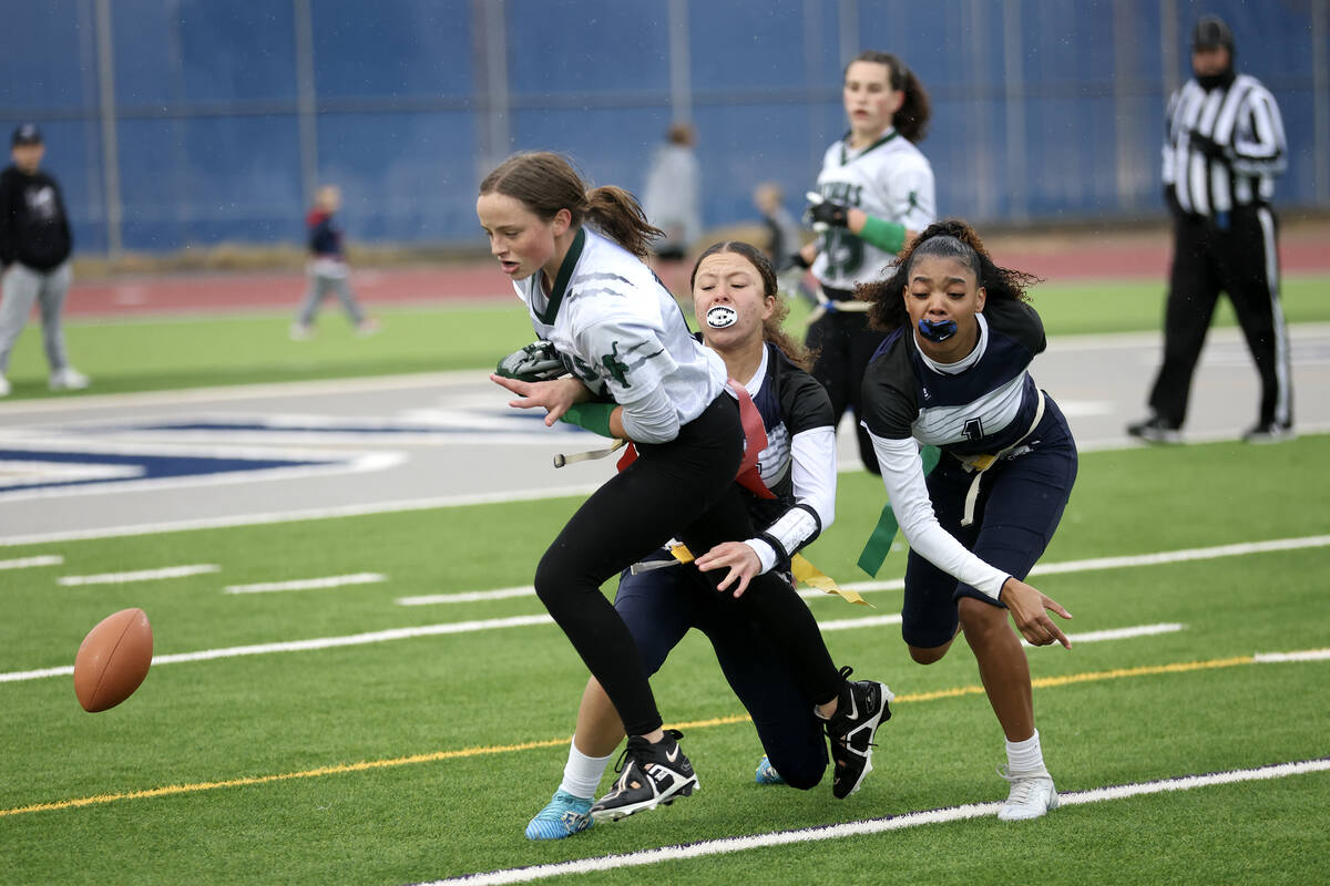 Shadow Ridge's Mariah Stevens-Walden, center, and Kyliah Rivera-Kyle (1) break up a touchdown p ...