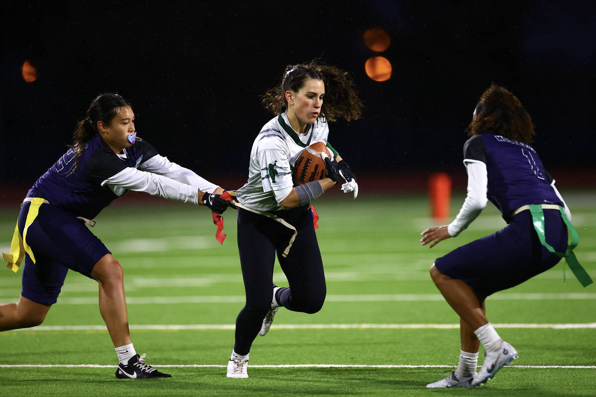 Shadow Ridge's Jaylani Palmer (12) takes the flag of Palo Verde's Olivia Perkins (25) during th ...