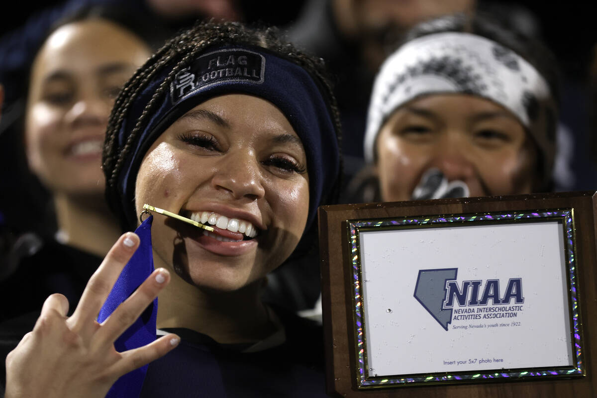 Shadow Ridge's Miracle Taylor poses with her team’s trophy after they beat Palo Verde in ...
