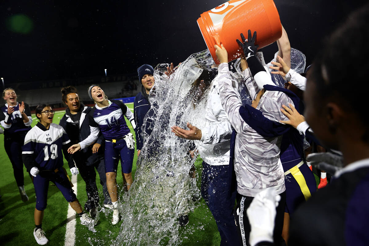Shadow Ridge dumps a water cooler on head coach Matthew Nighswonger after they defeated Palo Ve ...
