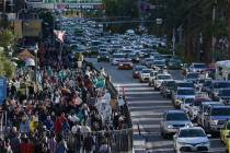 Crowds of people and backed up traffic on the Strip are seen the day before Super Bowl LVIII Sa ...