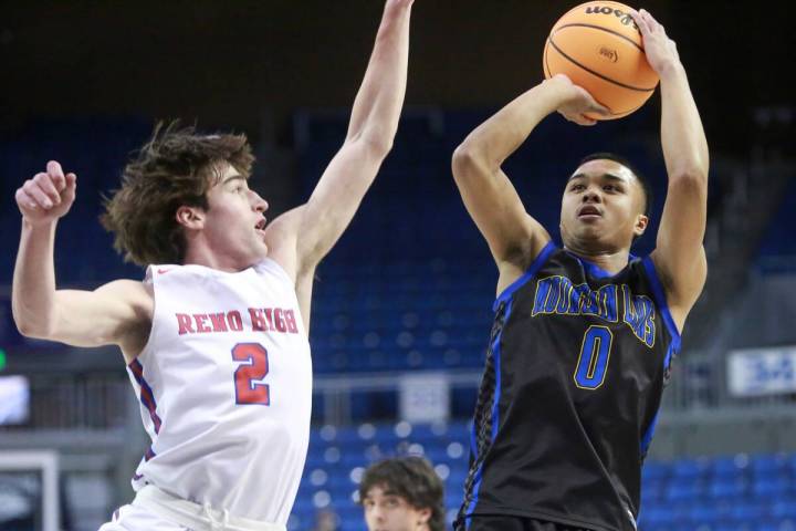 Sierra Vista junior guard EJ Dacuma, right, fades away while shooting a jumper against Reno sen ...