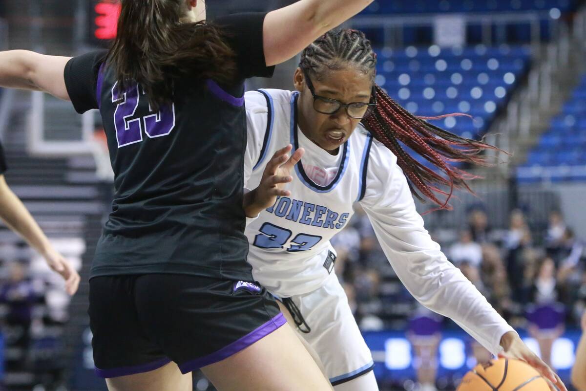 Canyon Springs senior center Kenijae Cherry, right, drives the lane against Spanish Springs sen ...