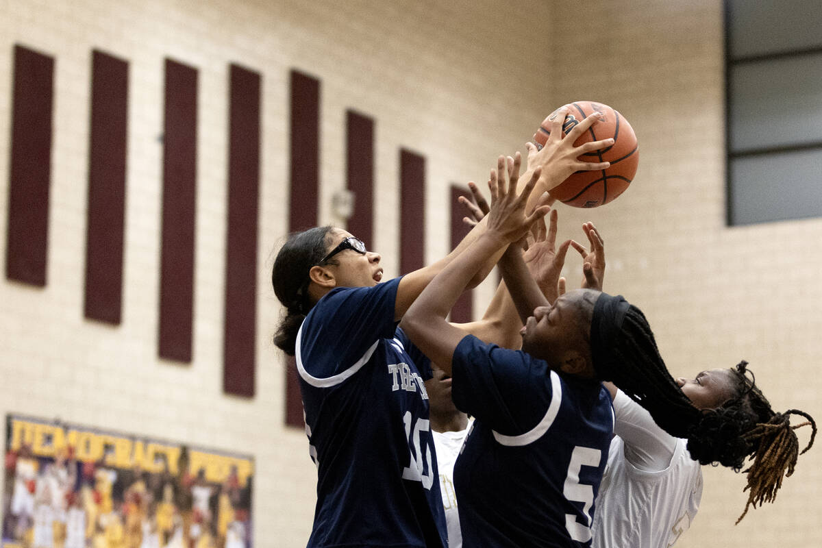 Shadow Ridge struggles for the ball with Democracy Prep during a girls high school basketball g ...