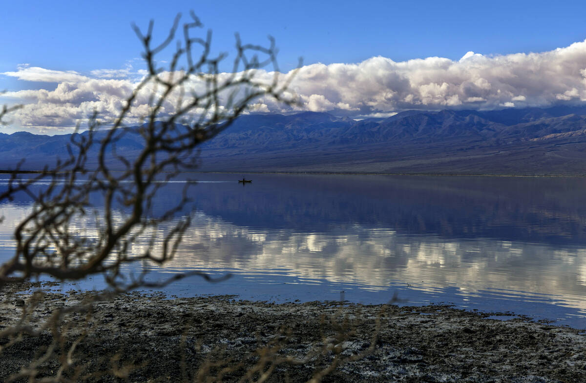 People paddle on kayaks on the temporary Lake Manly at Badwater Basin in Death Valley National ...