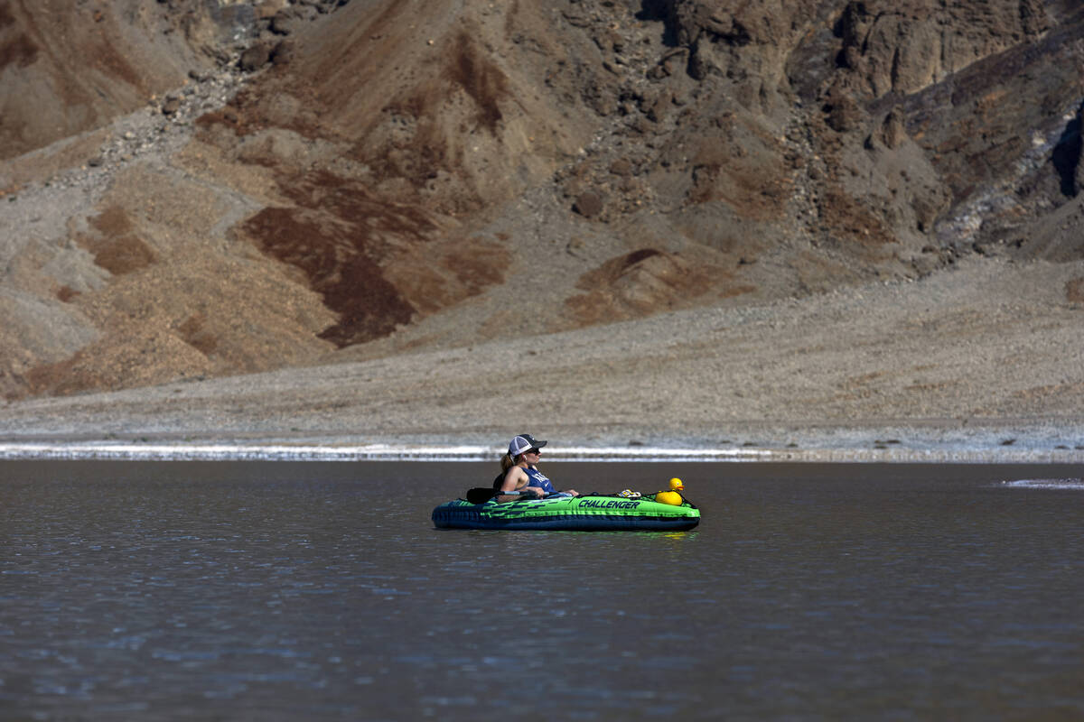 A visitor kayaks on the temporary Lake Manly at Badwater Basin in Death Valley National Park on ...