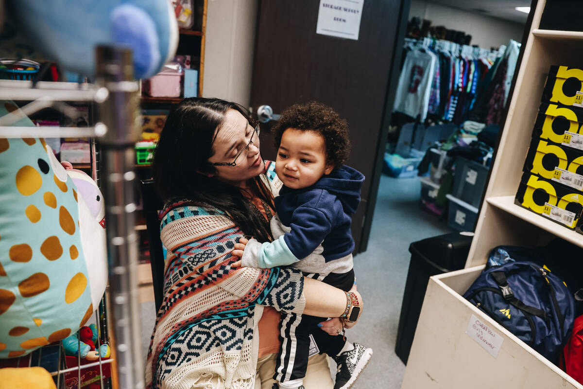 Katie Krikorian, left, holds her adopted son, Isaac Krikorian, 1, at Peggy’s Attic on th ...