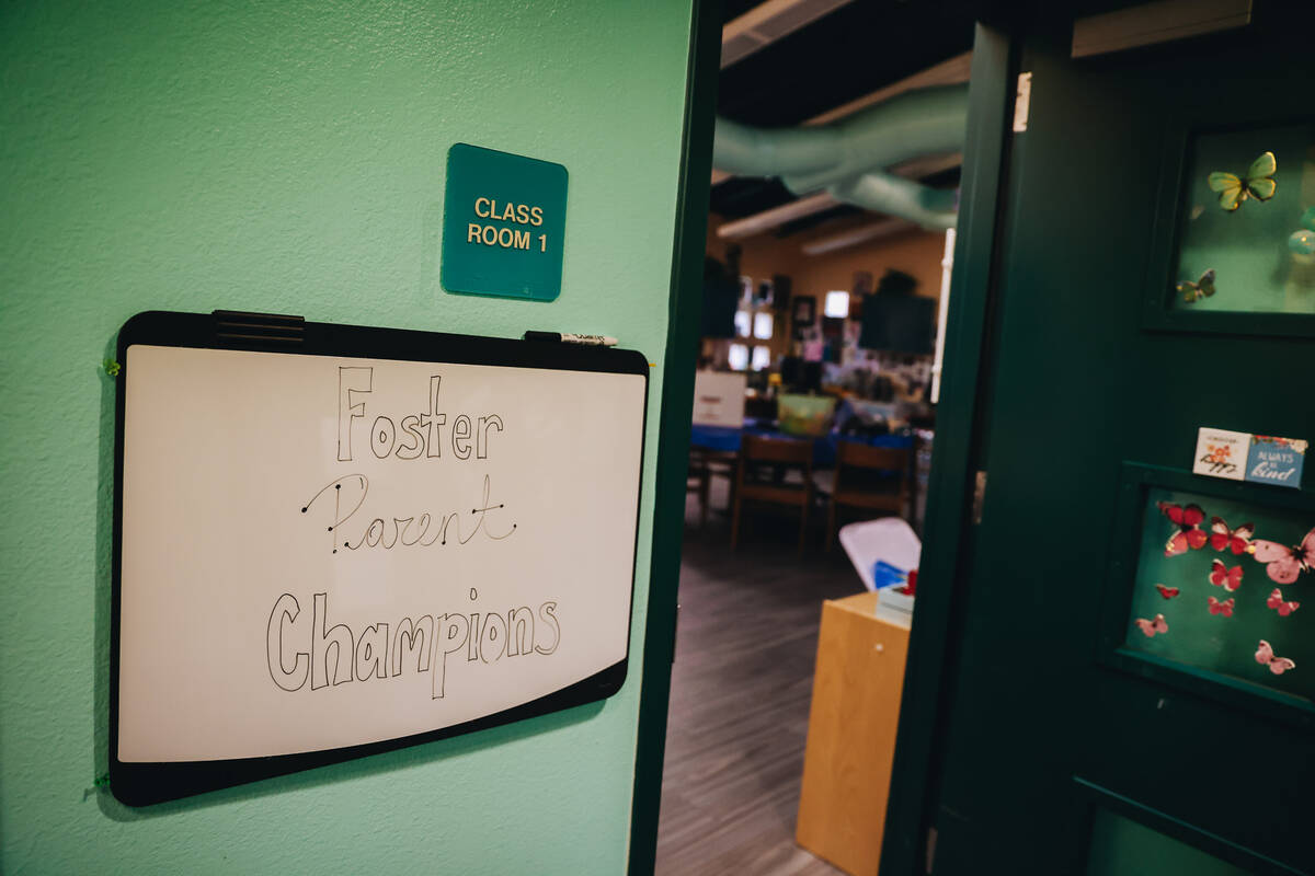 A “Foster Parent Champions” sign is seen at the entrance of an administrative room on the C ...