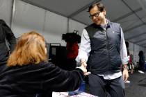 Nevada Secretary State Cisco Aguilar shakes hands with poll worker Esmeralda Reynold during pri ...