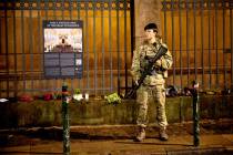 FILE - A soldier of the Danish Army (Forsvaret) guards the Copenhagen Synagogue, Saturday Dec. ...