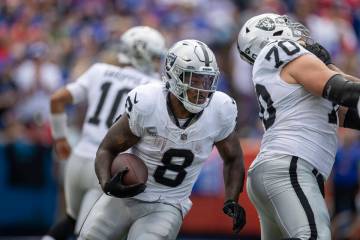 Raiders running back Josh Jacobs (8) looks for room to run against the Buffalo Bills during the ...