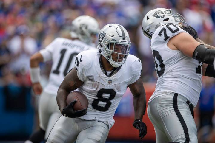 Raiders running back Josh Jacobs (8) looks for room to run against the Buffalo Bills during the ...