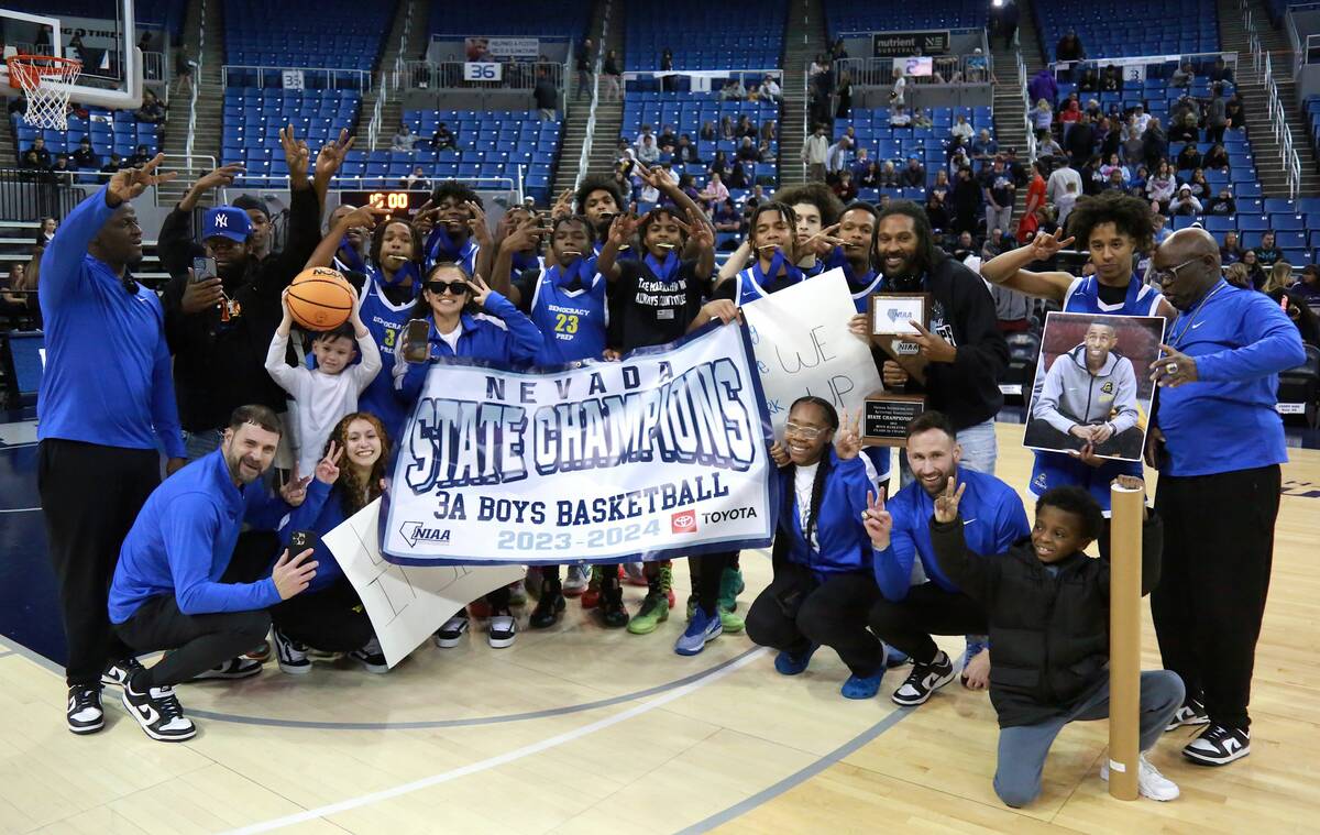 The Democracy Prep Blue Knights celebrate after winning the Class 3A boys basketball state cham ...