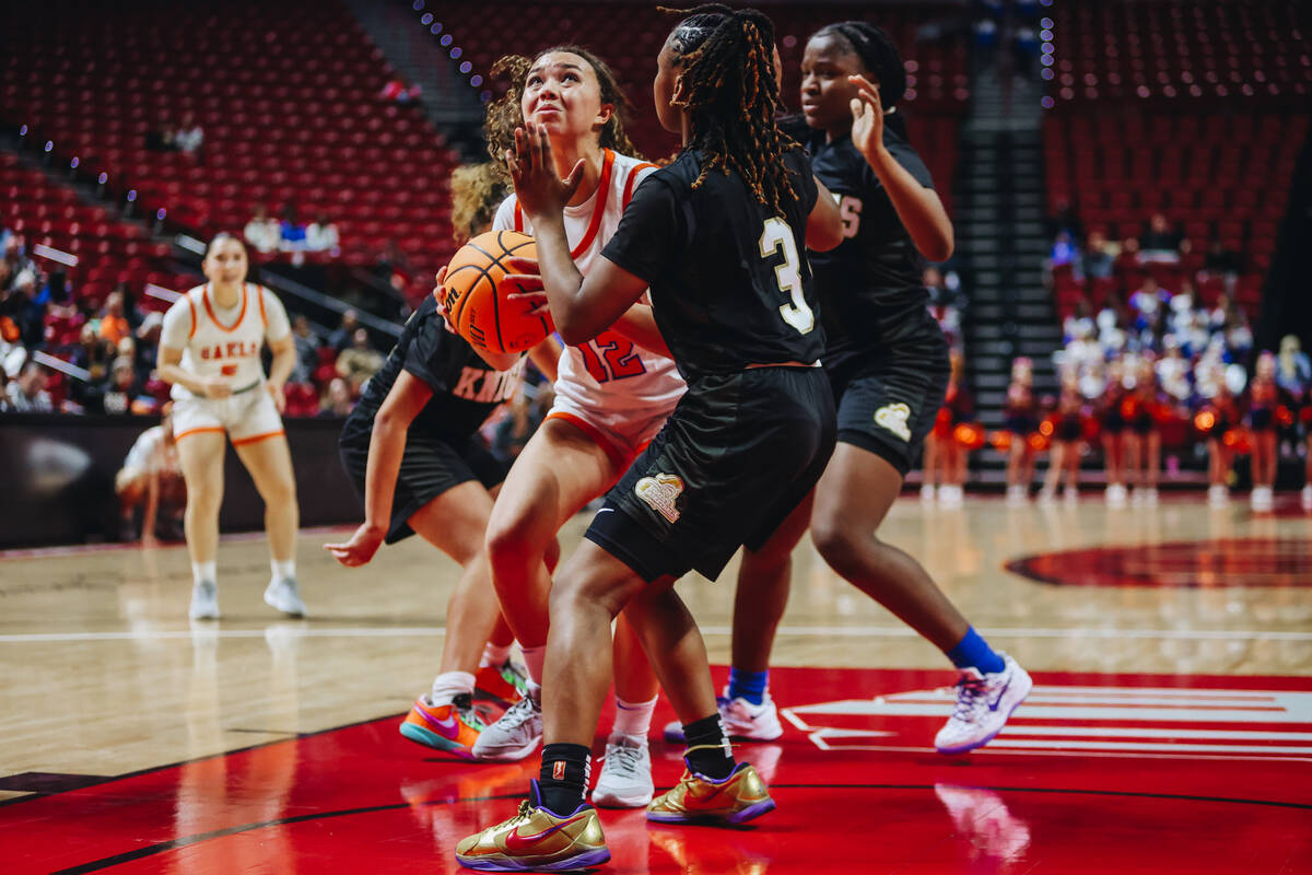 Bishop Gorman guard Addysen Carr (12) looks to make a basket as Democracy Prep defenders surrou ...