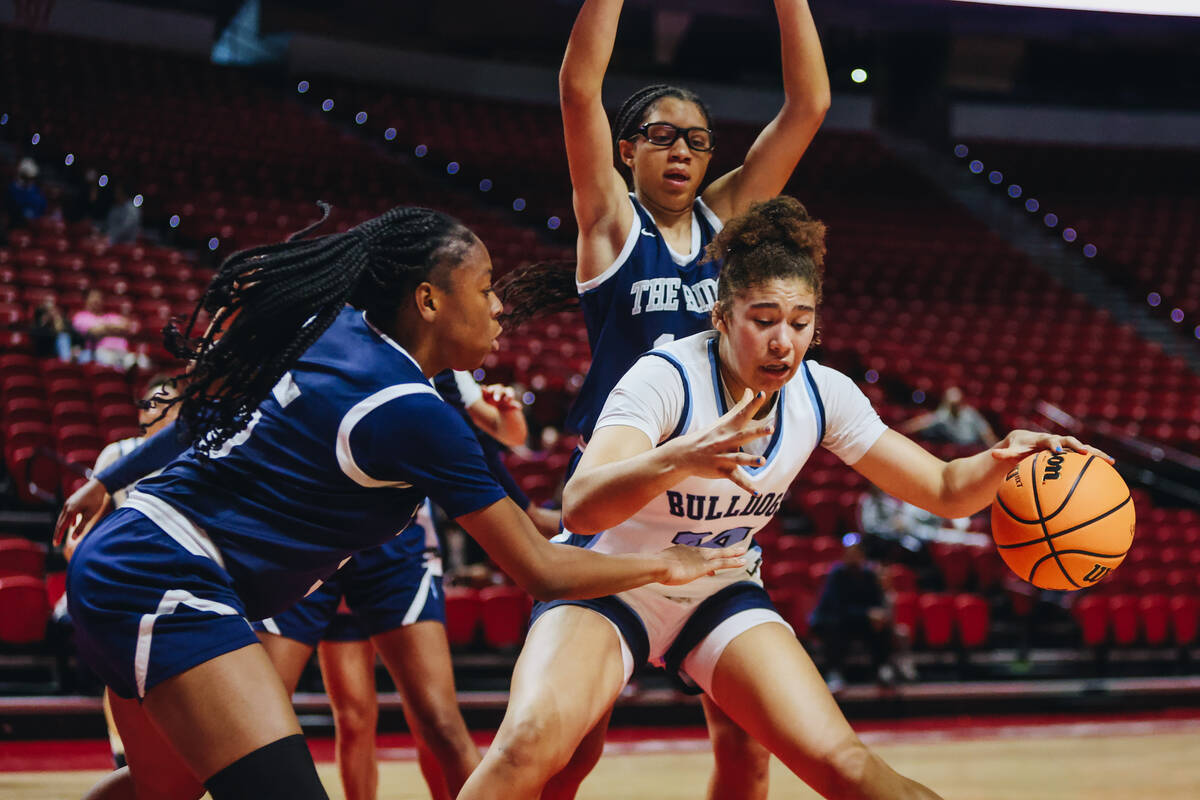 Centennial’s Nation Williams (24) keeps the ball from a Shadow Ridge defender during a Class ...