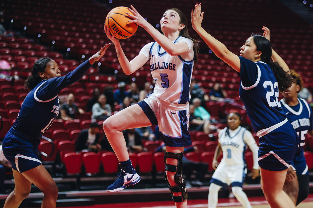 Centennial’s Trysta Barrett (5) goes for a layup during a Class 5A girls basketball stat ...