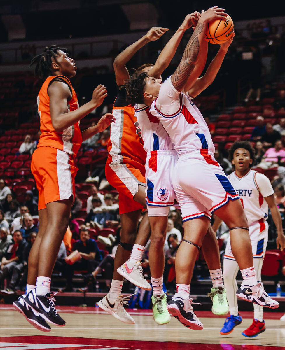 Liberty small forward Andre Porter (5) grabs the ball before Bishop Gorman can rebound during a ...