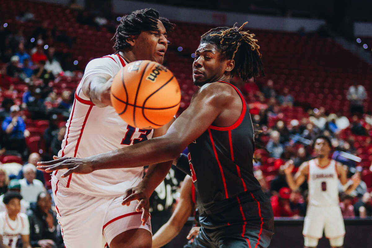 Coronado center Tee Bartlett (13) passes the ball to a teammate during a Class 5A boys basketba ...