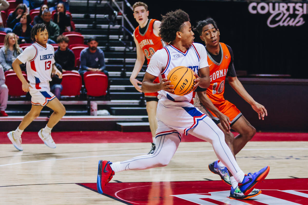 Liberty point guard Tyus Thomas (0) drives the ball onto the paint during a Class 5A boys baske ...