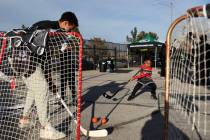 Kids play with the Vegas Golden Knights street hockey set up during an opening event at the Don ...