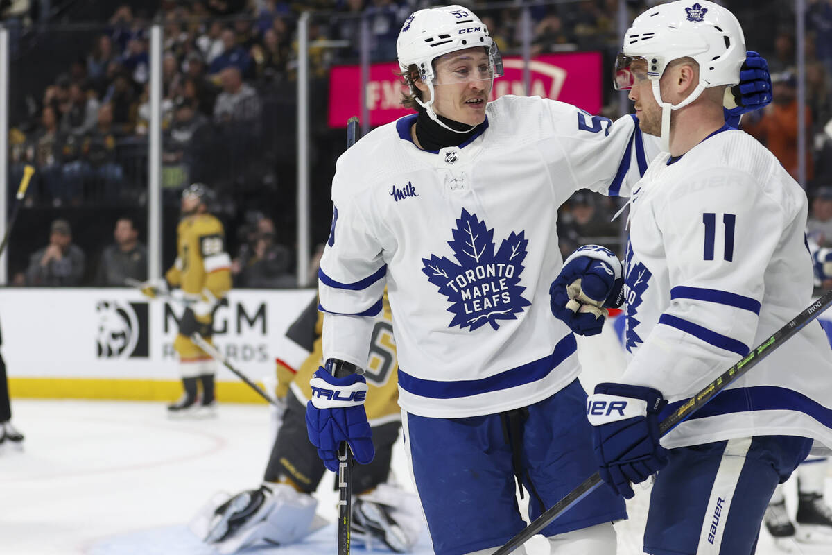 Toronto Maple Leafs left wing Tyler Bertuzzi (59) celebrates with center Max Domi (11) after Do ...