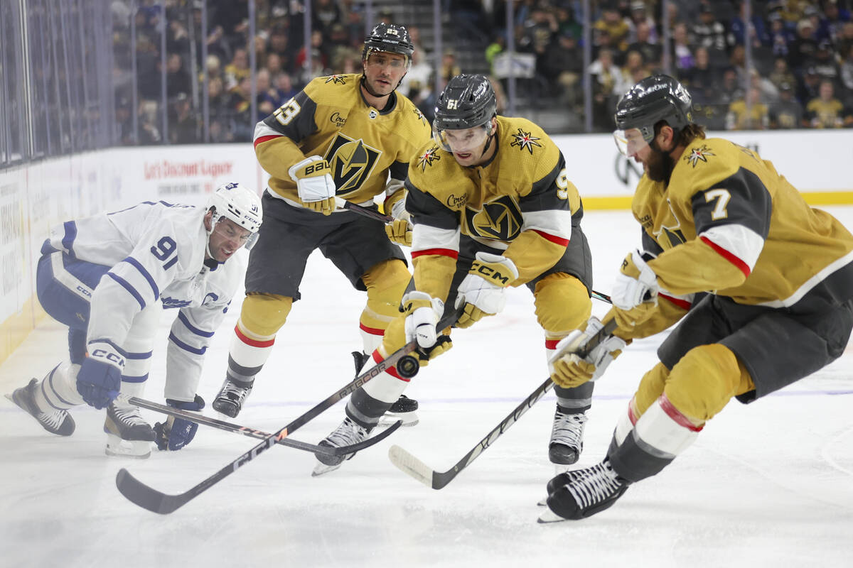 Vegas Golden Knights center Byron Froese (51) and defenseman Alex Pietrangelo (7) chase the puc ...