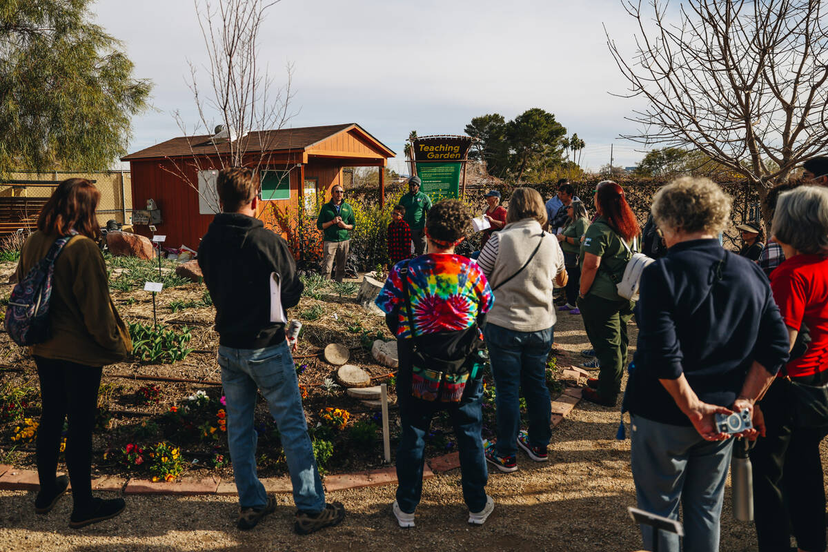 Ian Ford-Terry, an archaeologist at Springs Preserve, speaks to a crowd in the Teaching Garden ...