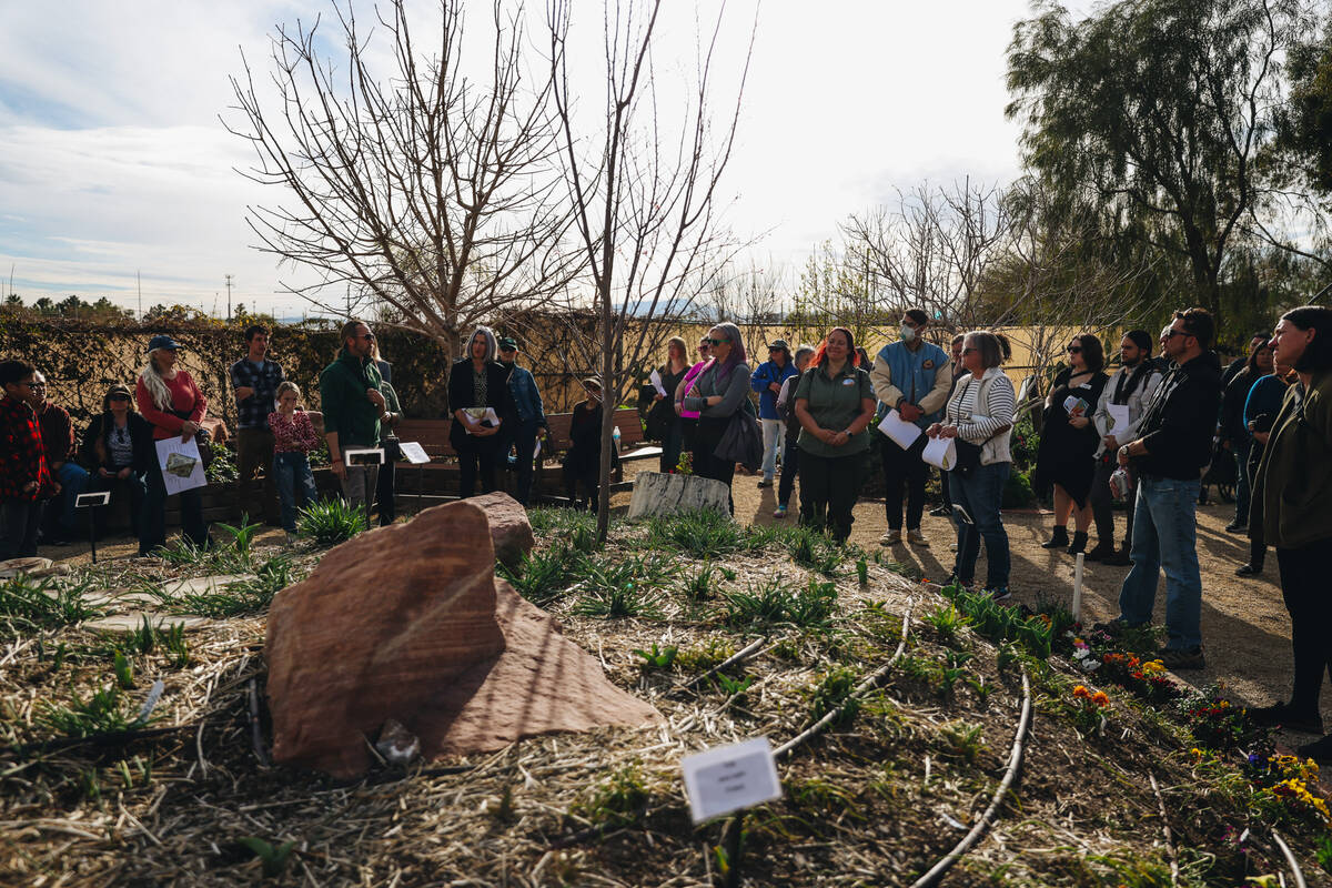 A crowd listens to a presentation during a tour in the Teaching Garden at Springs Preserve on S ...