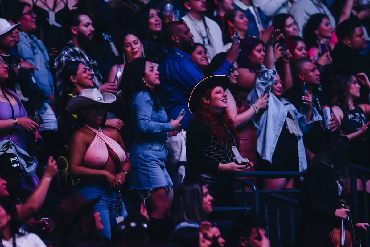 Bad Bunny fans watch as the singer performs during his Most Wanted Tour at T-Mobile Arena on Fr ...