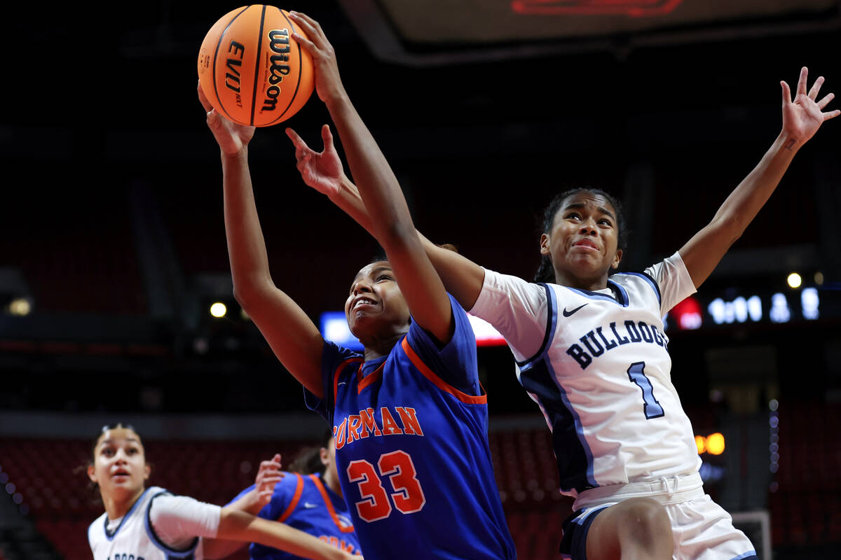 Bishop Gorman's Neeyah Webster (33) snags a rebound over Centennial's Azaia Tatum (1) during th ...