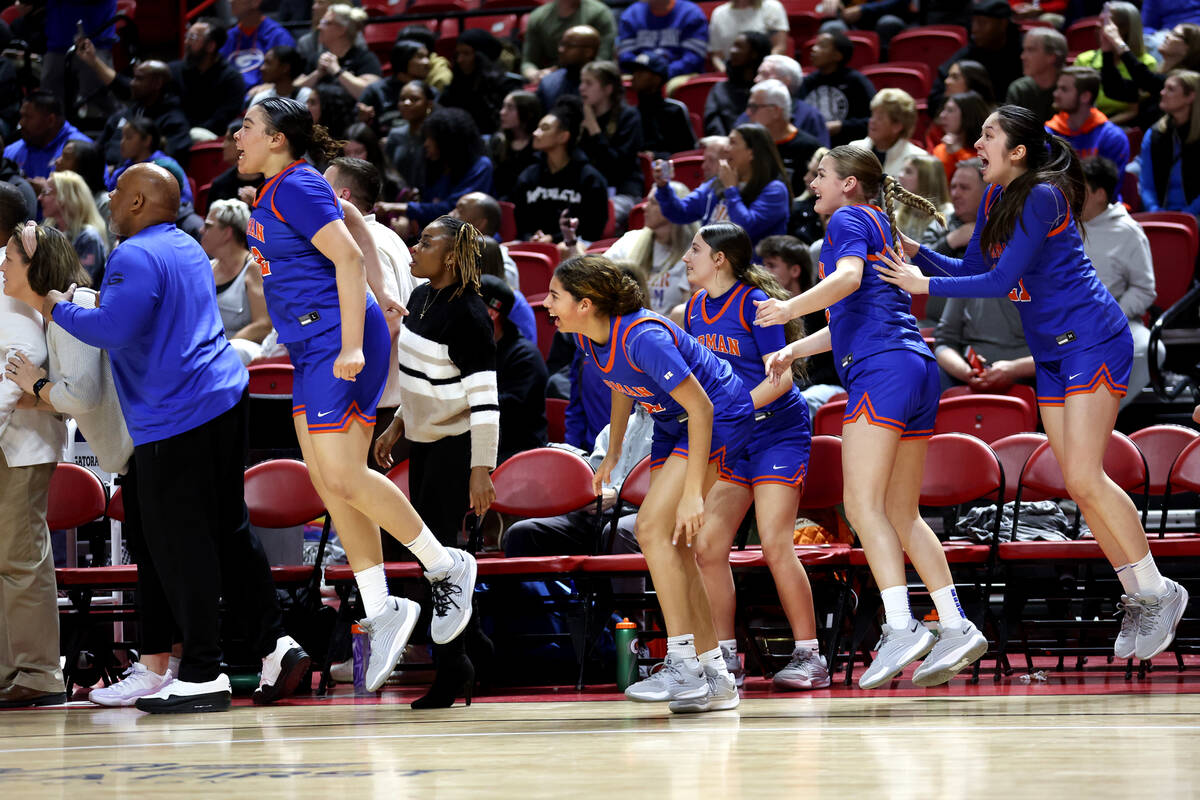 The Bishop Gorman bench jumps as the clock runs out in the Class 5A girls basketball state cham ...