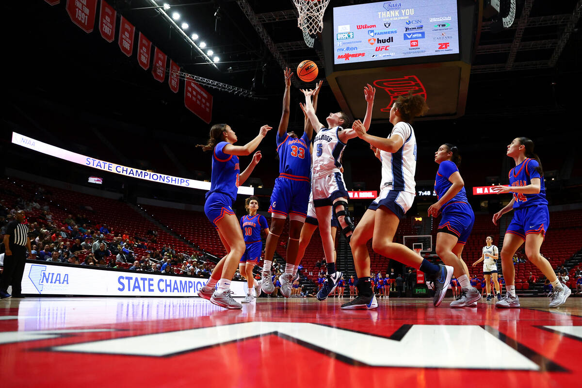 Bishop Gorman's Neeyah Webster (33) and Centennial's Trysta Barrett (5) jump for a rebound duri ...