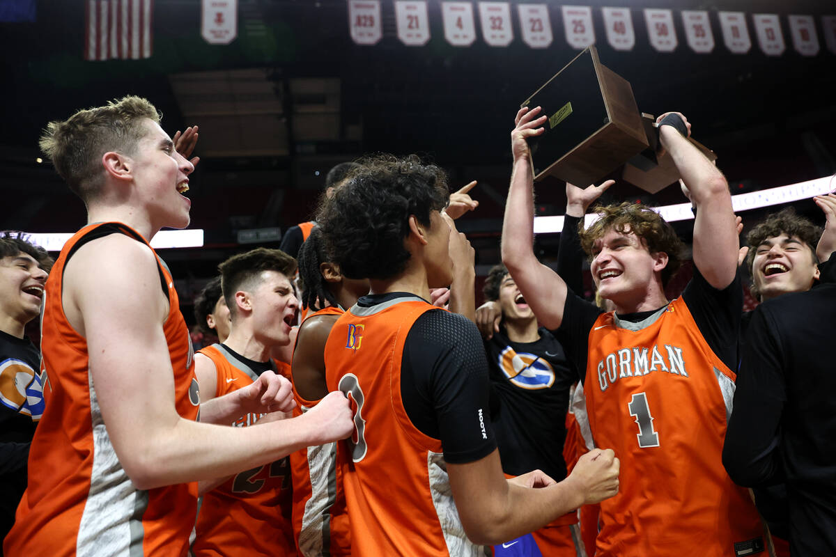 Bishop Gorman celebrates with their trophy after defeating Coronado in the Class 5A boys basket ...
