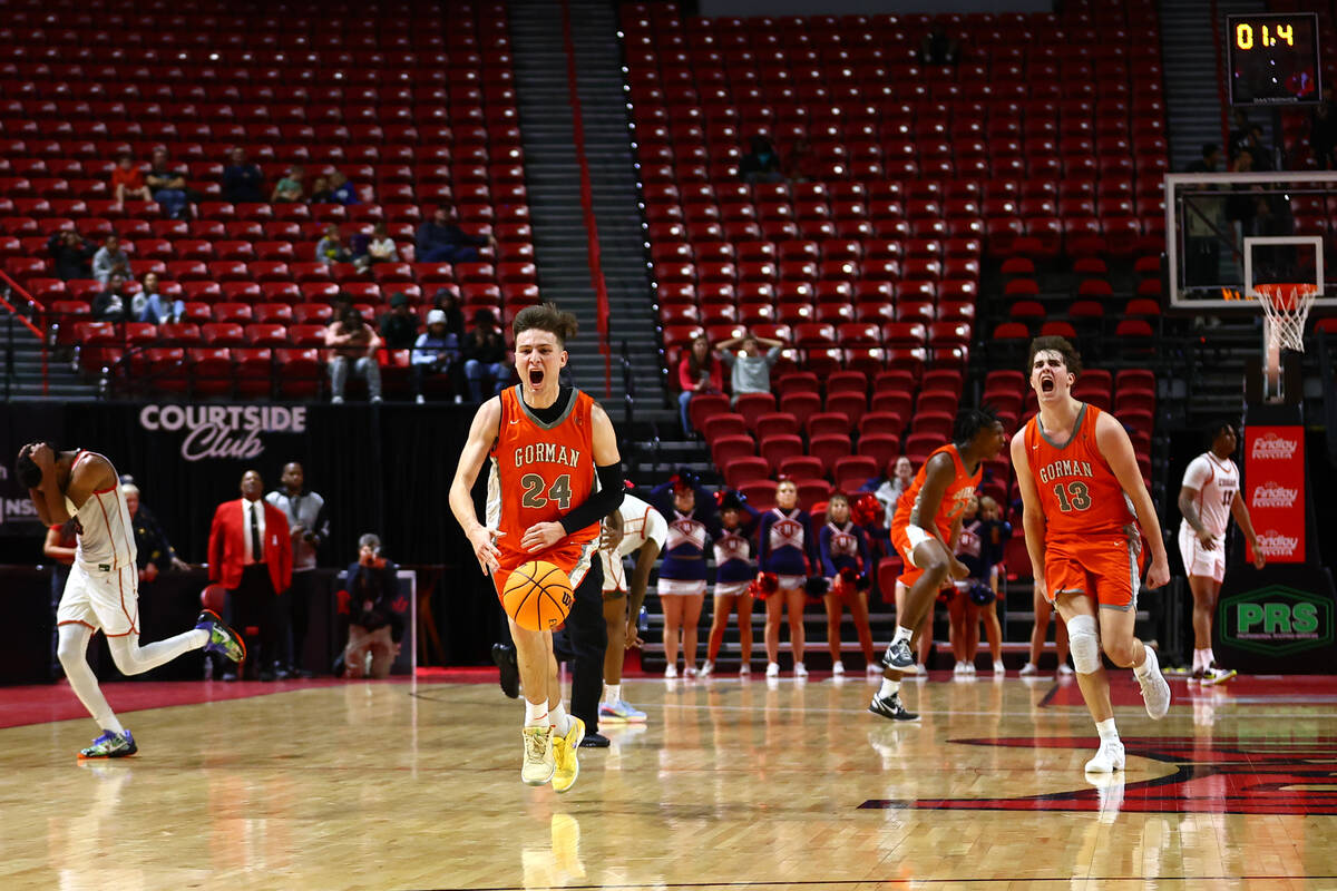 Bishop Gorman's Ryder Elisaldez (24) and Noah Westbrook (13) celebrate after drawing a foul wit ...