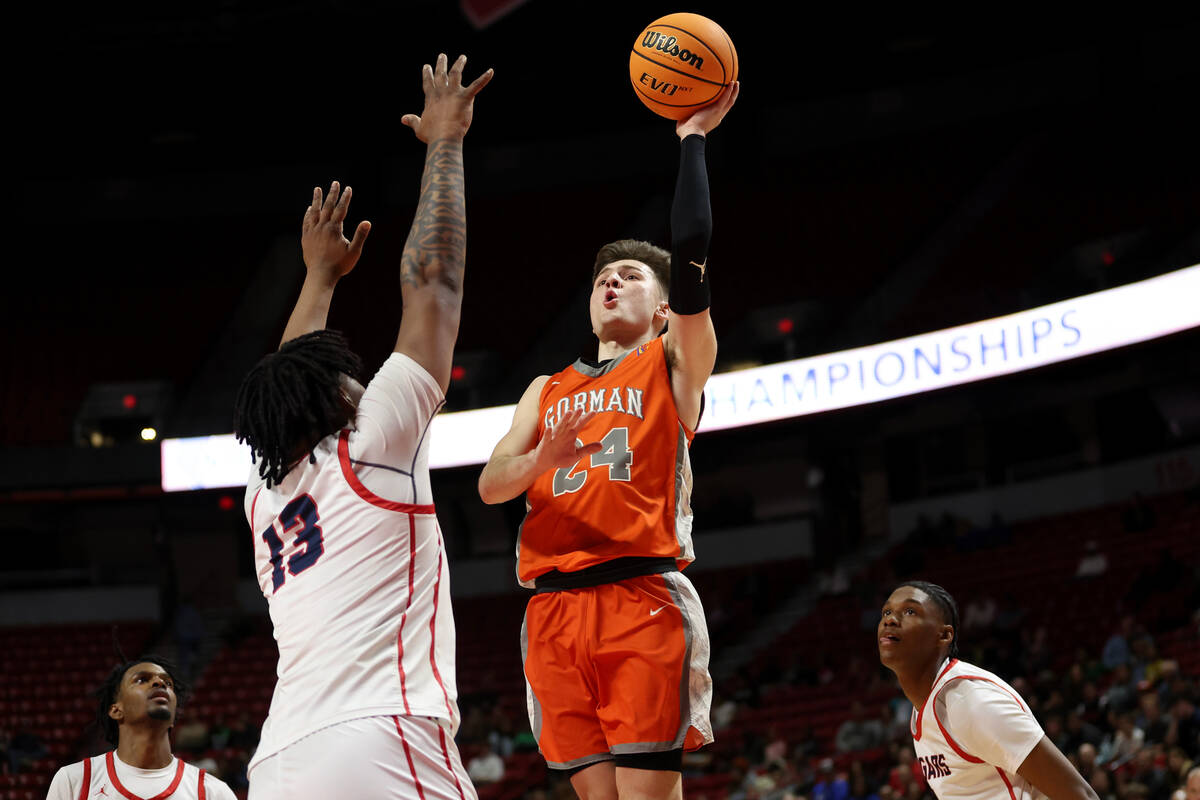 Bishop Gorman's Ryder Elisaldez (24) shoots against Coronado's Tee Bartlett (13) during the sec ...