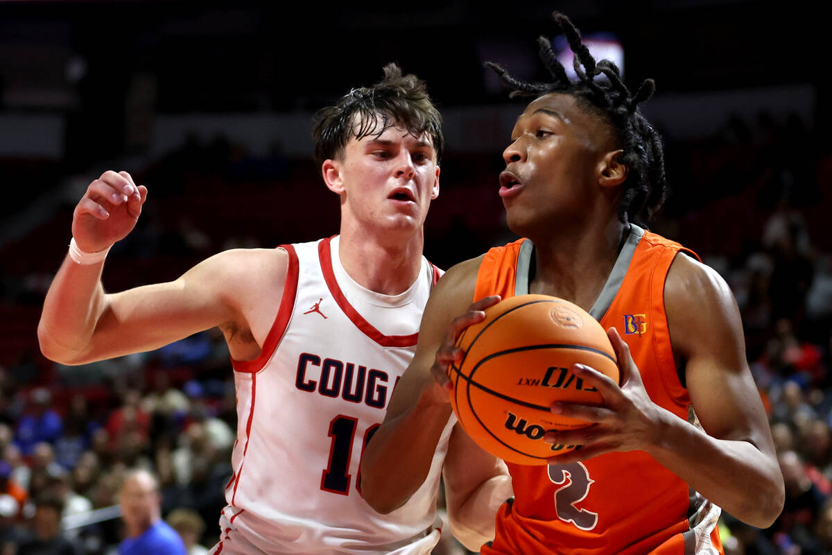 Bishop Gorman's Jett Washington (2) drives toward the hoop against Coronado's JJ Buchanan (10) ...