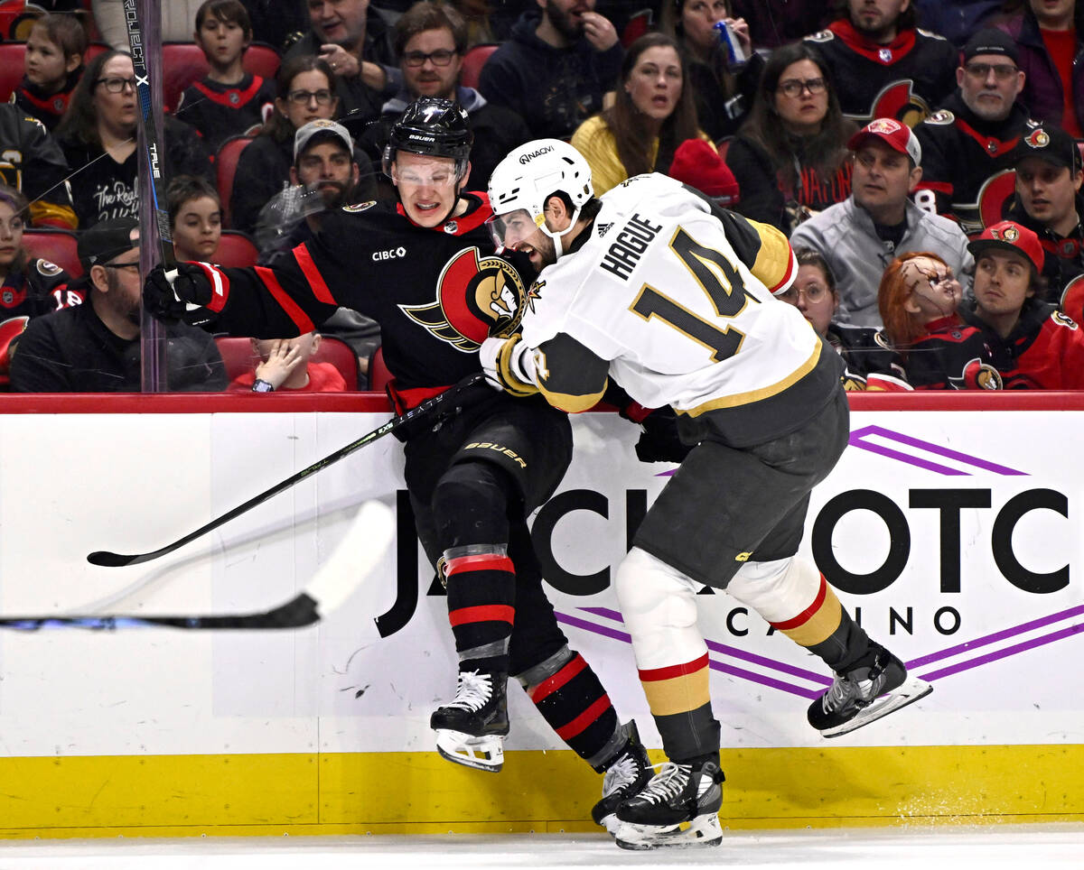Ottawa Senators left wing Brady Tkachuk (7) crashes into the boards with Vegas Golden Knights d ...