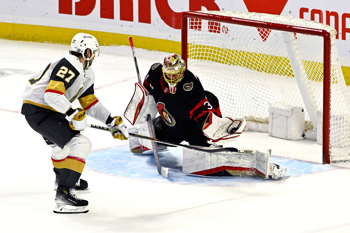 Ottawa Senators goaltender Anton Forsberg (31) makes a save on Vegas Golden Knights defenweman ...