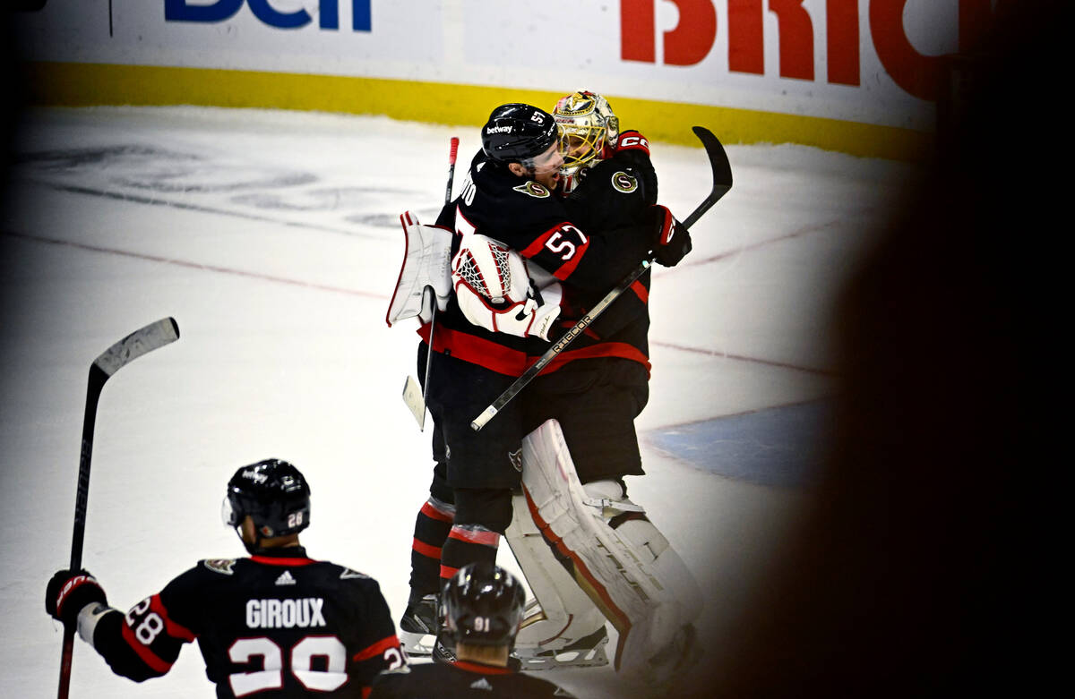 Ottawa Senators goaltender Anton Forsberg (31) is embraced by center Shane Pinto (57) after mak ...