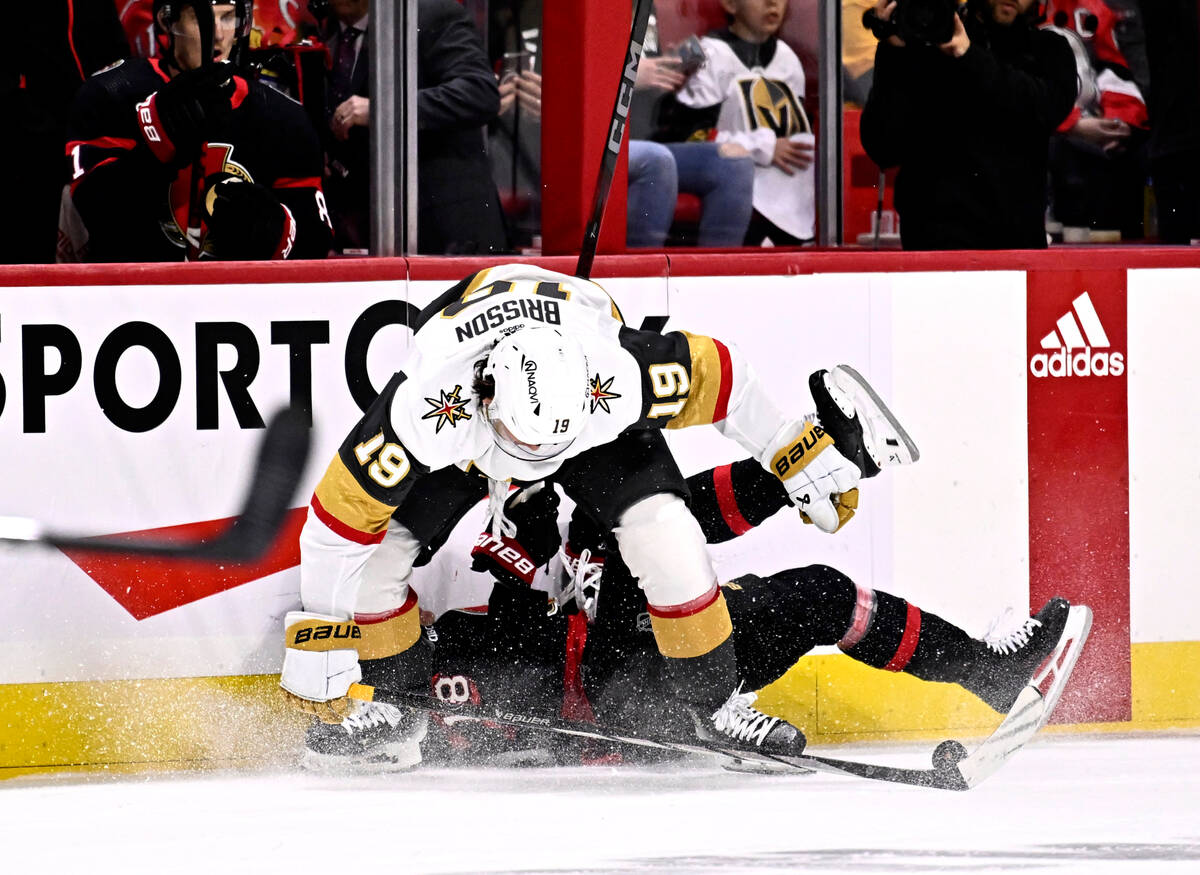 Ottawa Senators center Tim Stutzle (18) gets knocked down by Vegas Golden Knights center Brenda ...