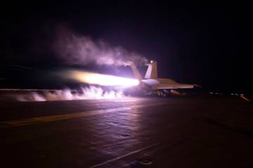 This image provided by the U.S. Navy shows an aircraft launching from USS Dwight D. Eisenhower ...
