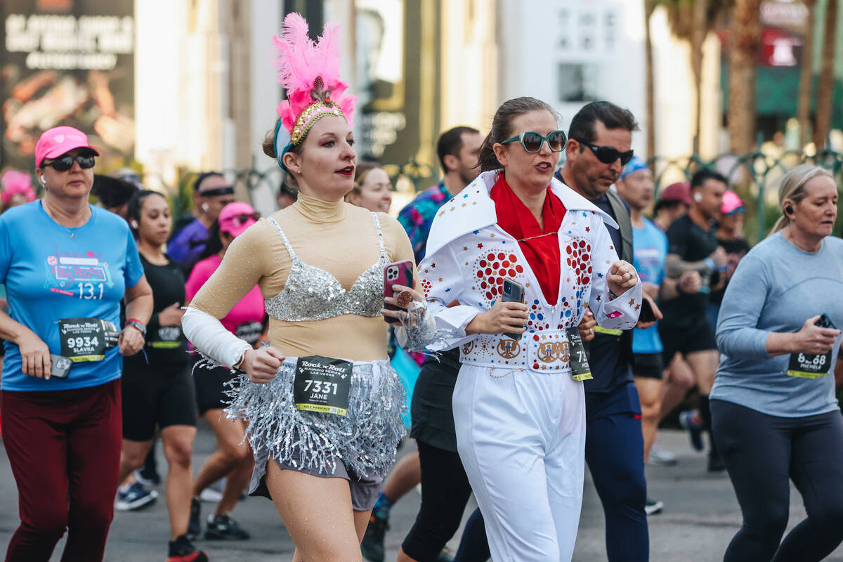 Runners in a showgirl costume and an Elvis costume take to the Strip during the Rock ’n& ...