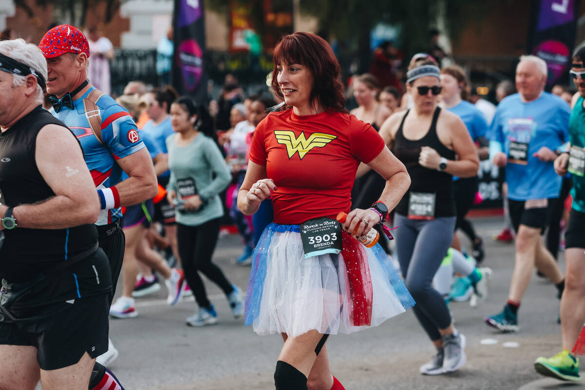 A runner dressed like Wonder Woman takes to the Strip during the Rock ’n’ Roll Ru ...