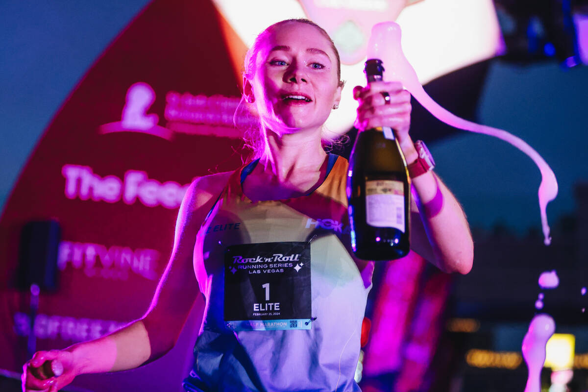 Alice Wright sprays champagne after coming in first for the women’s half marathon during ...