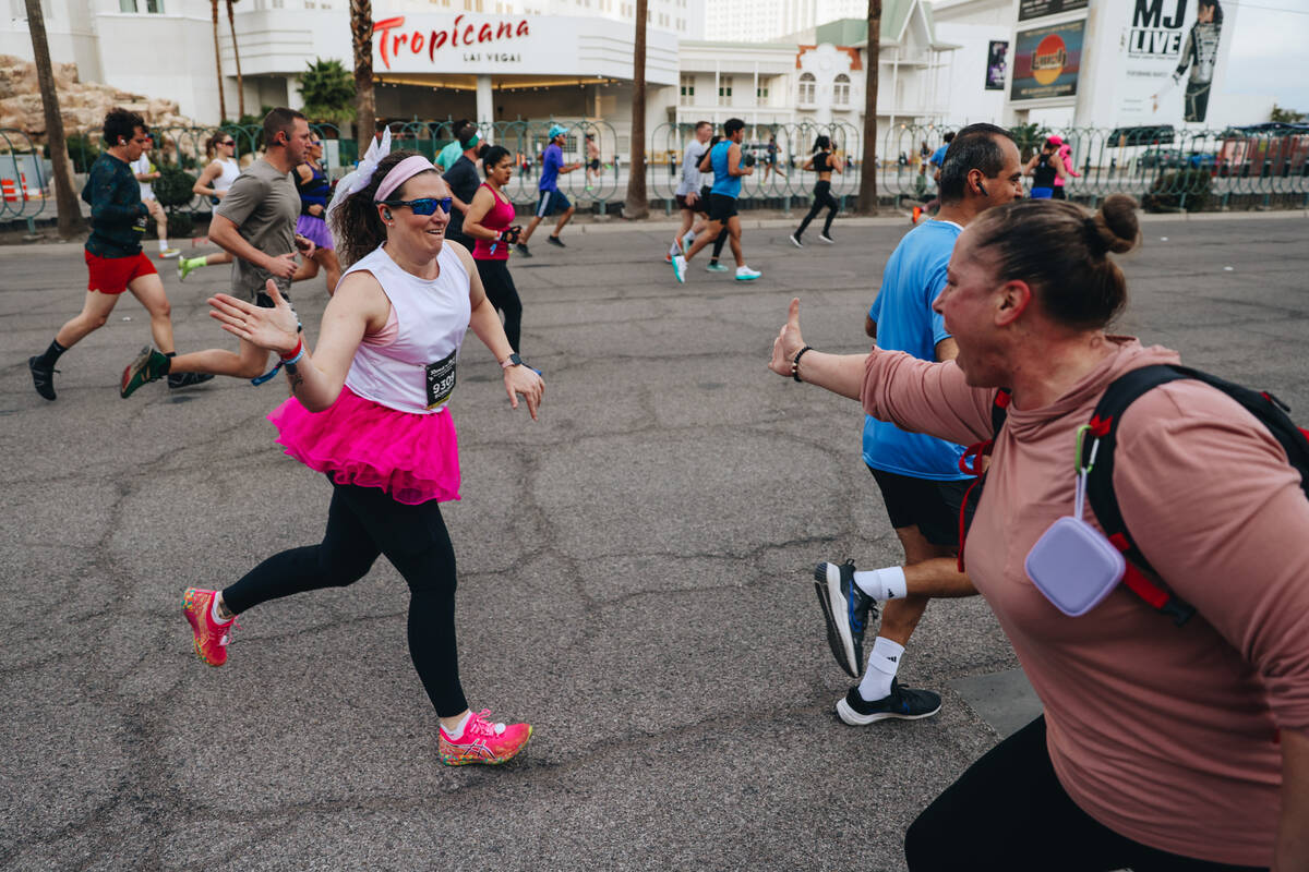A supporter high-fives a runner during the Rock ’n’ Roll Running Series on Las Ve ...
