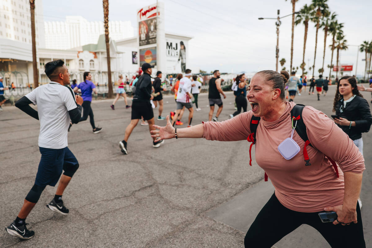 A supporter high-fives runners during the Rock ’n’ Roll Running Series on Las Veg ...