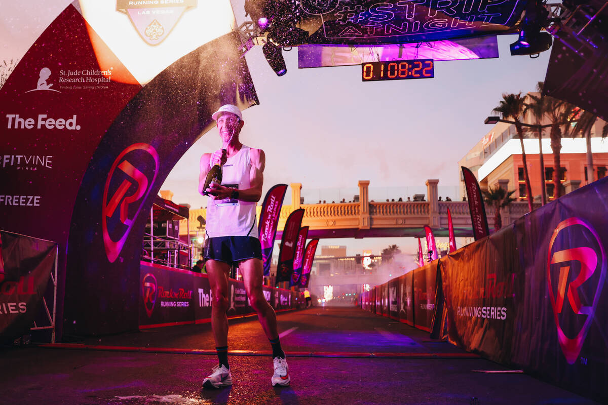 Andy Wacker sprays champagne after coming in first for the men’s half marathon during th ...