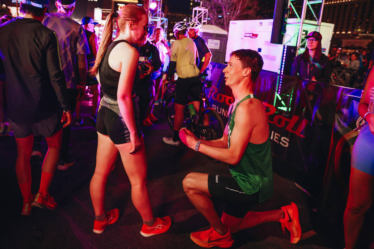 Mackenzie Mettille, right, proposes to his girlfriend, Courtney Clark, after running in the Roc ...