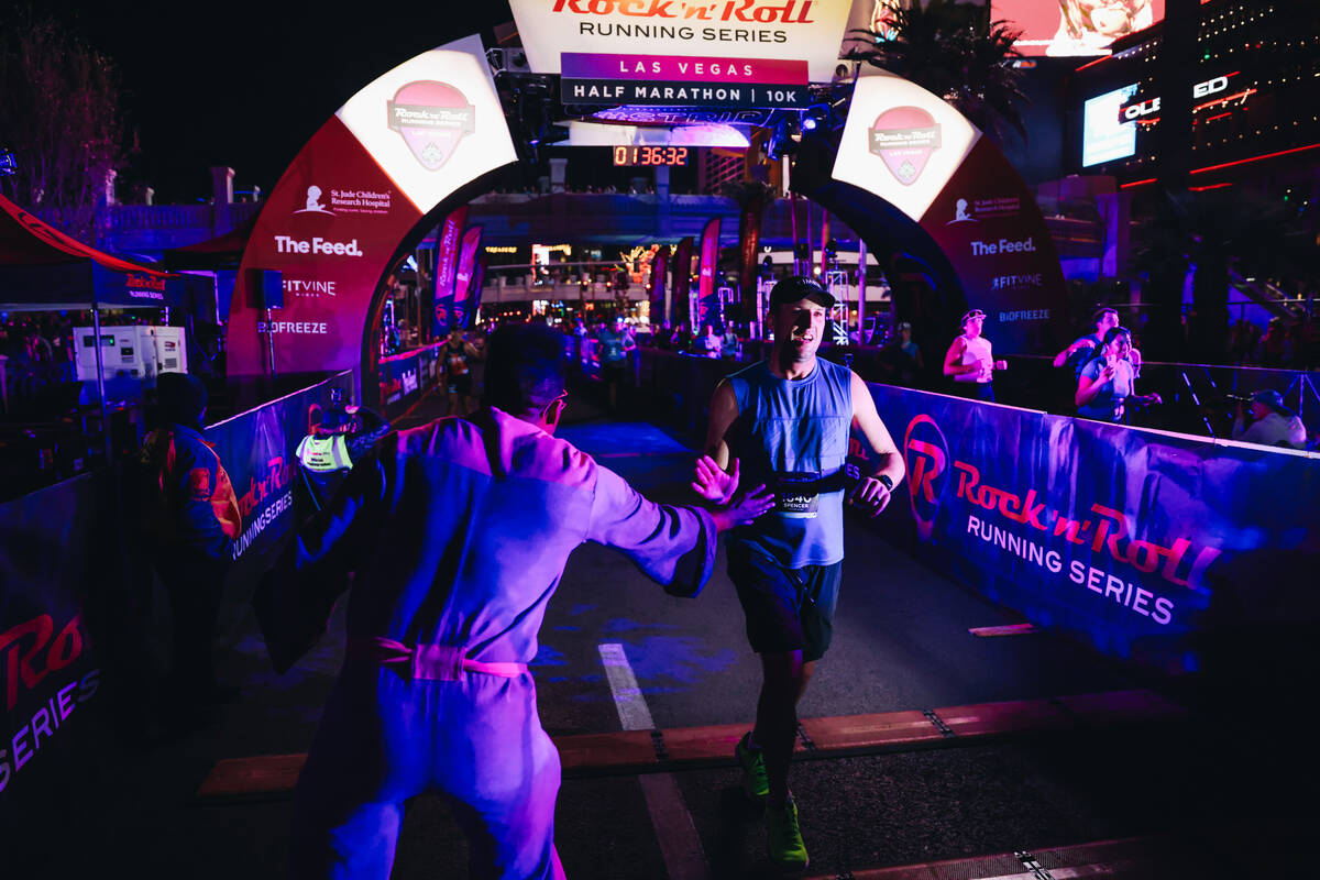 A runner crosses the finish line during the Rock ’n’ Roll Running Series on Las V ...