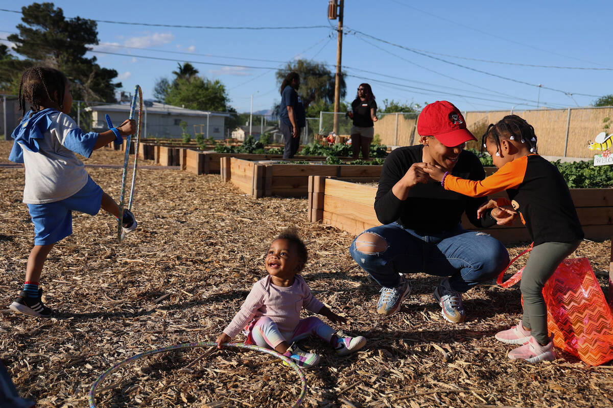 Ashleigh Donaby, right, plays with her daughter Zo’eigh, 3, near other children Nawi, 1, cent ...
